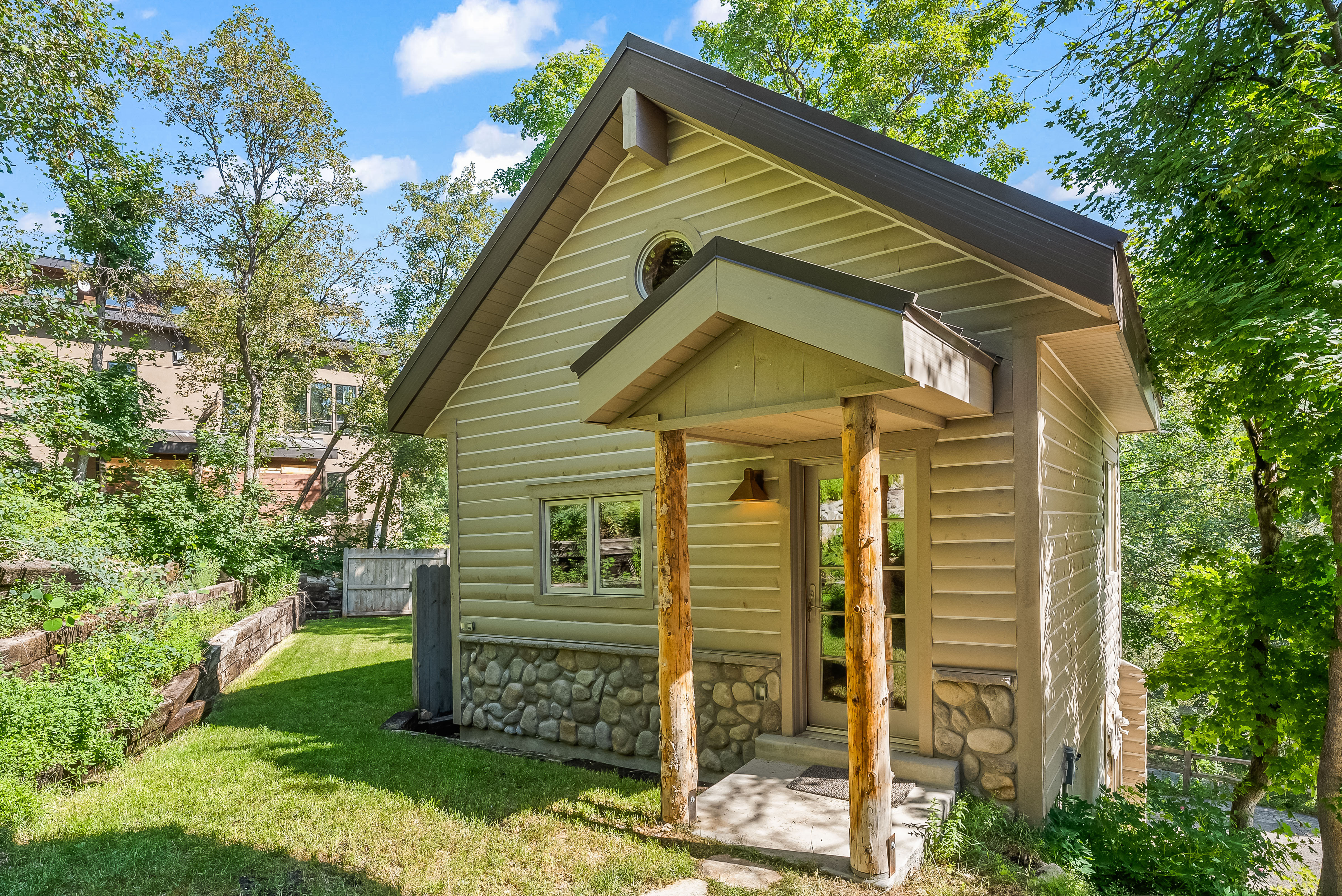 Charming exterior featuring horizontal siding and a natural stone foundation