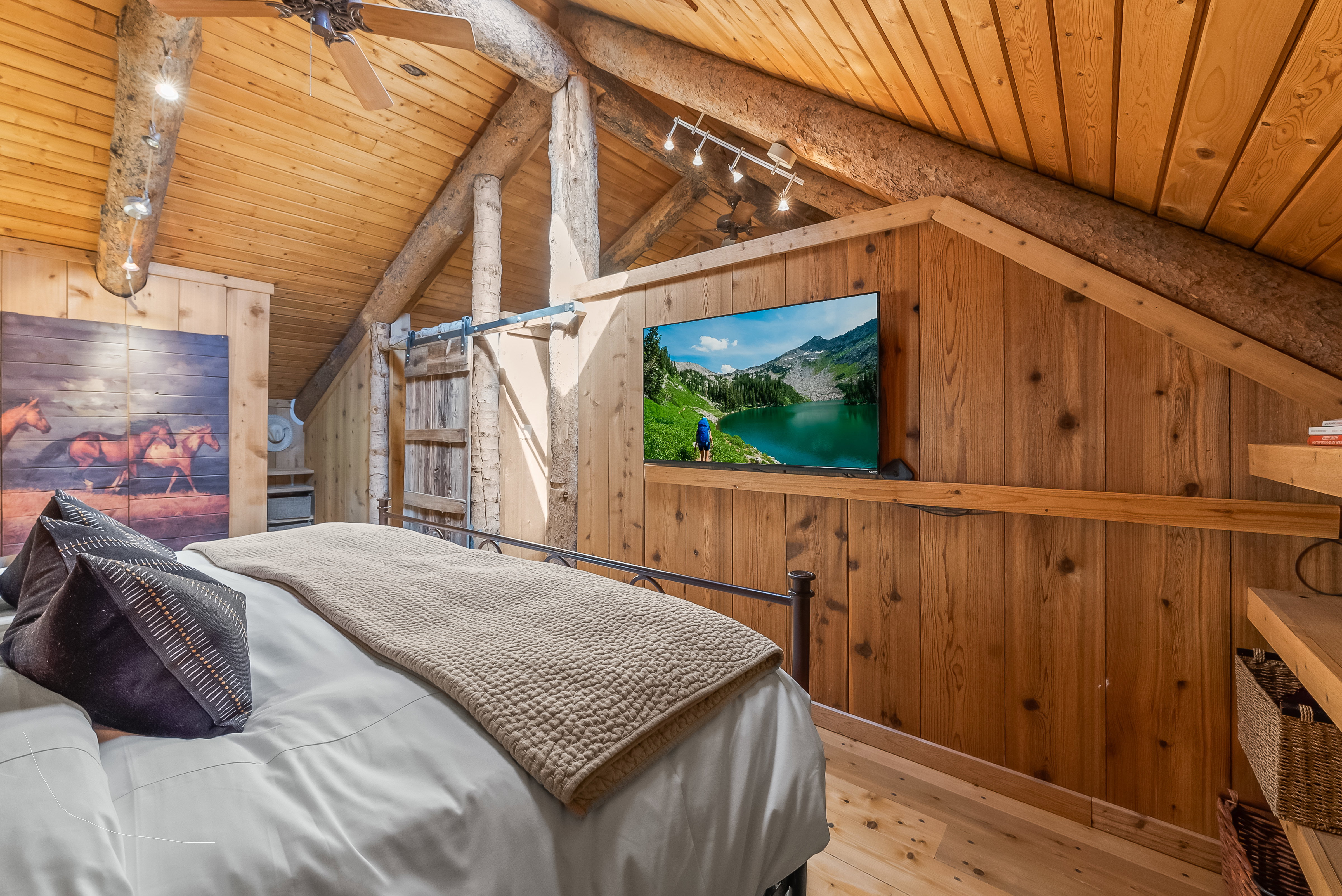 Vaulted wood-paneled ceiling with exposed log beams