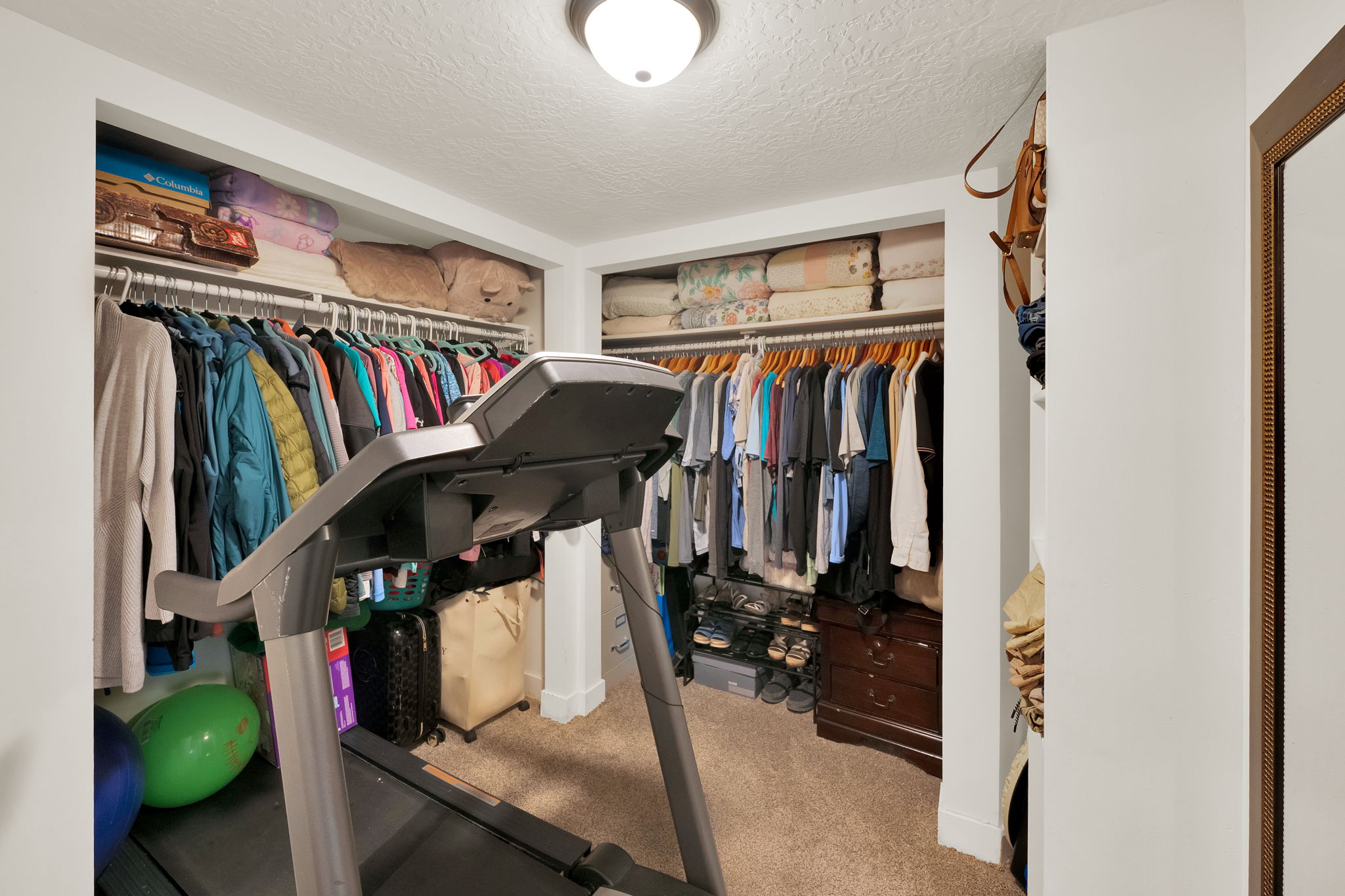 Carpeted interior space featuring white walls and a flush-mount ceiling light