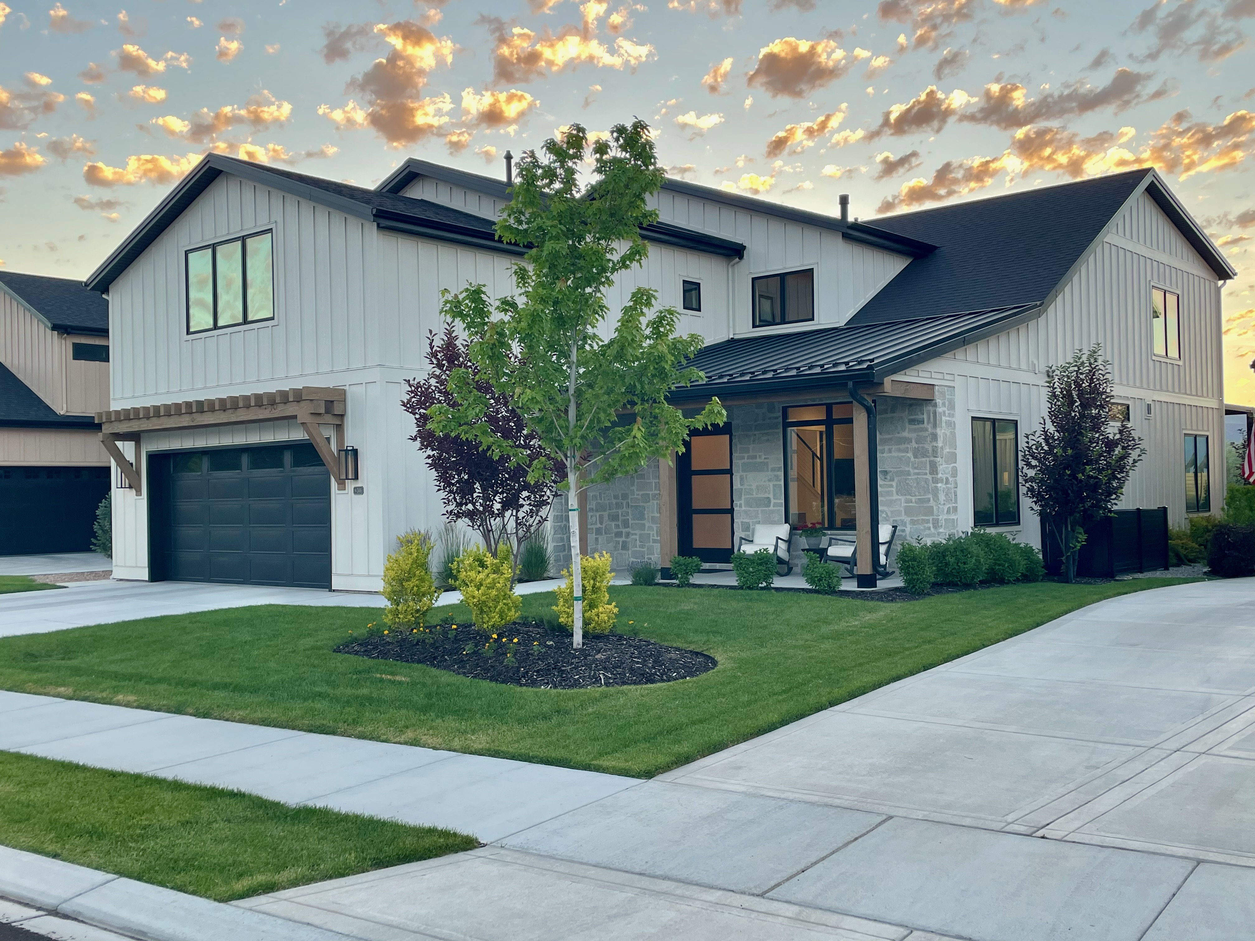Modern farmhouse exterior featuring board and batten siding and stone accents