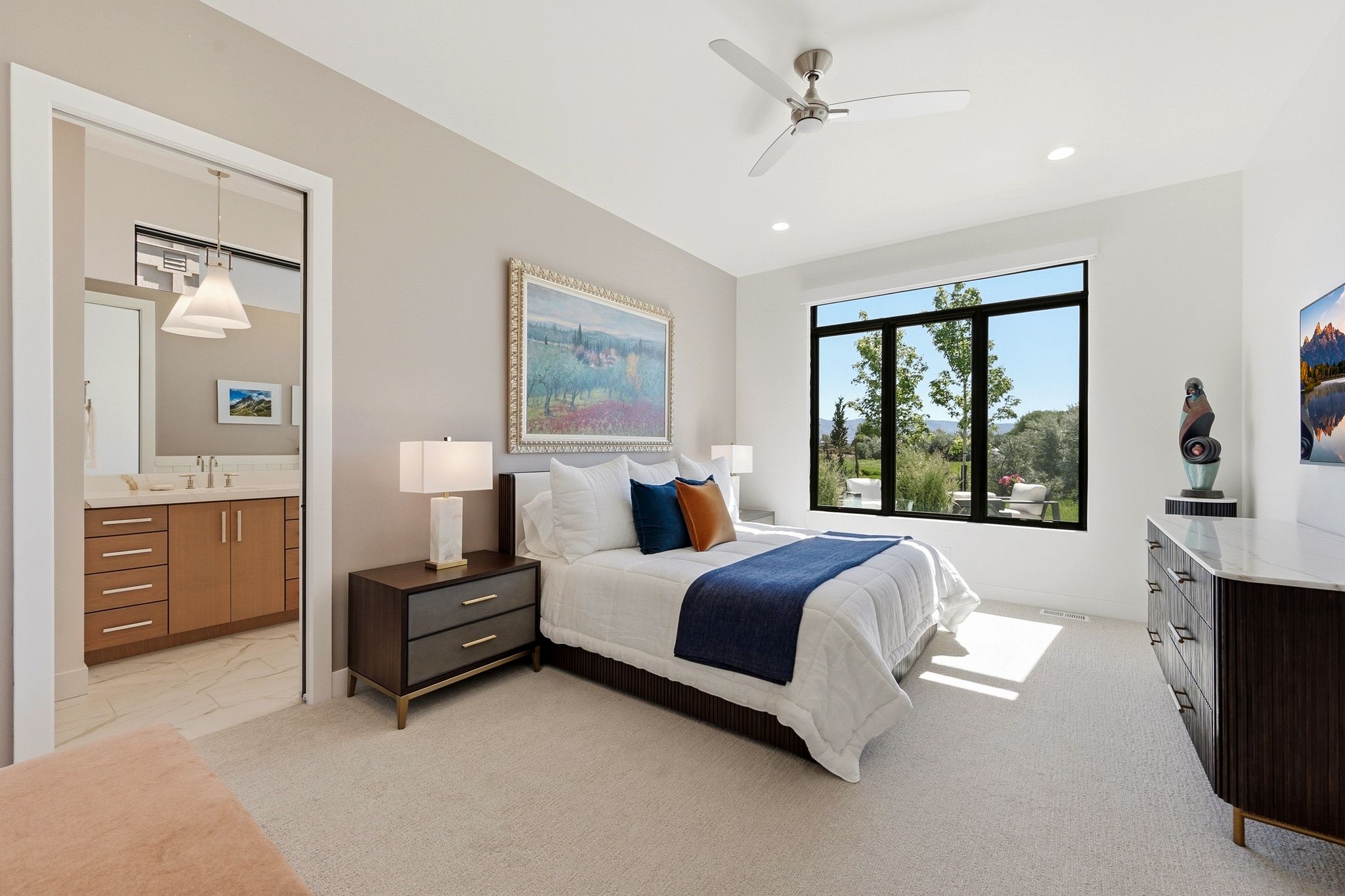 Bright room featuring a large window, recessed lighting, and a ceiling fan