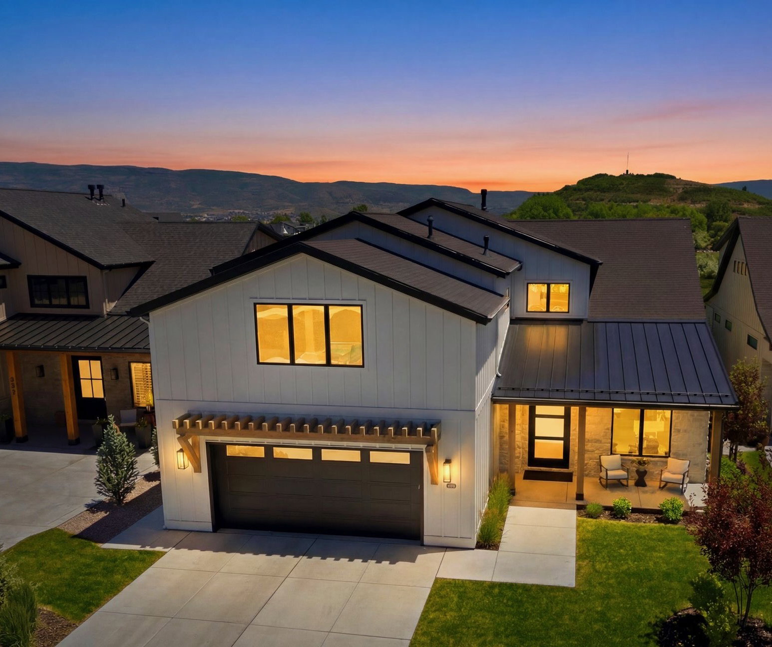 Modern farmhouse exterior with white siding and dark trim