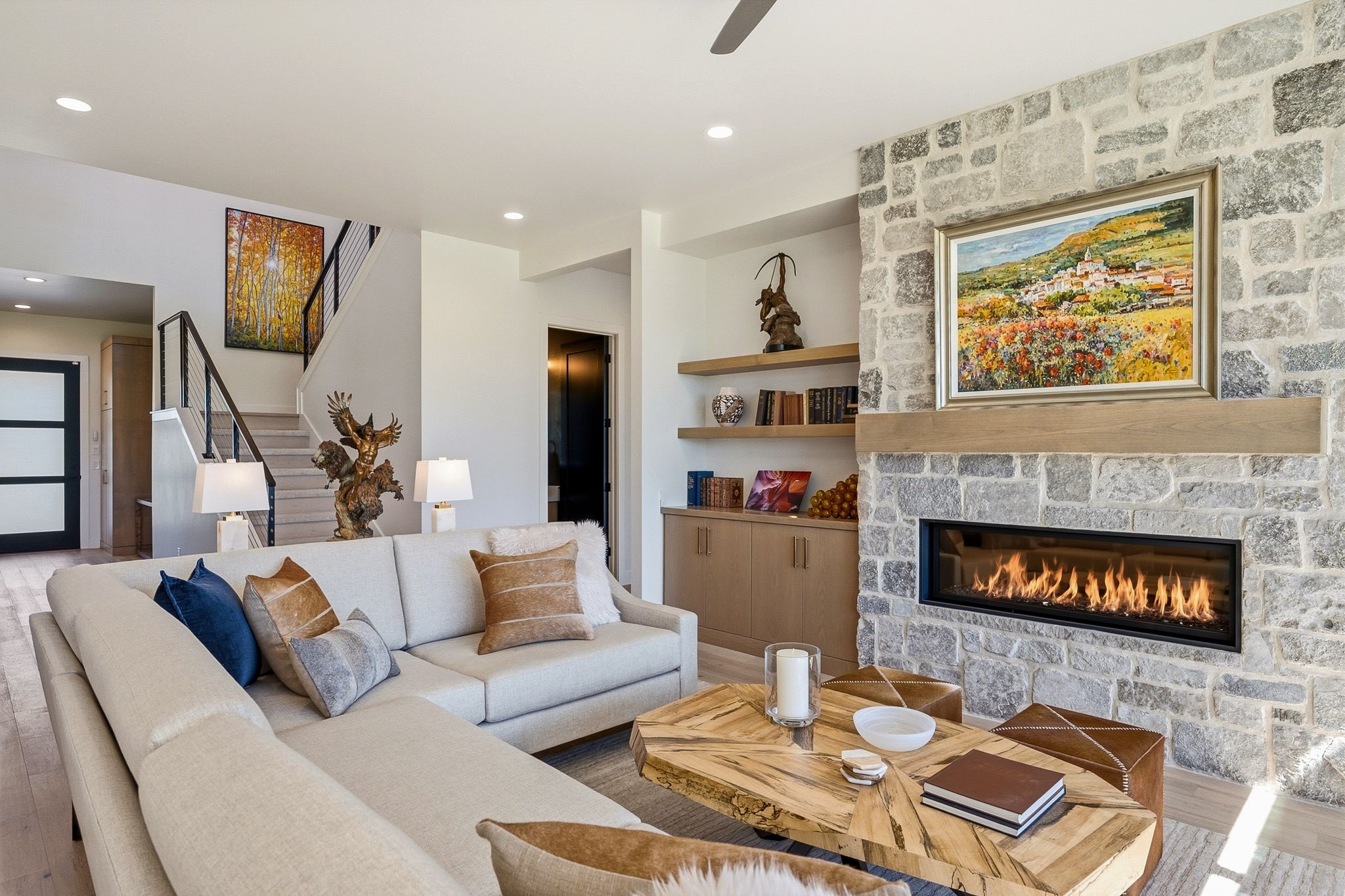Living area featuring a stone-clad fireplace with a linear firebox and a substantial wood mantel