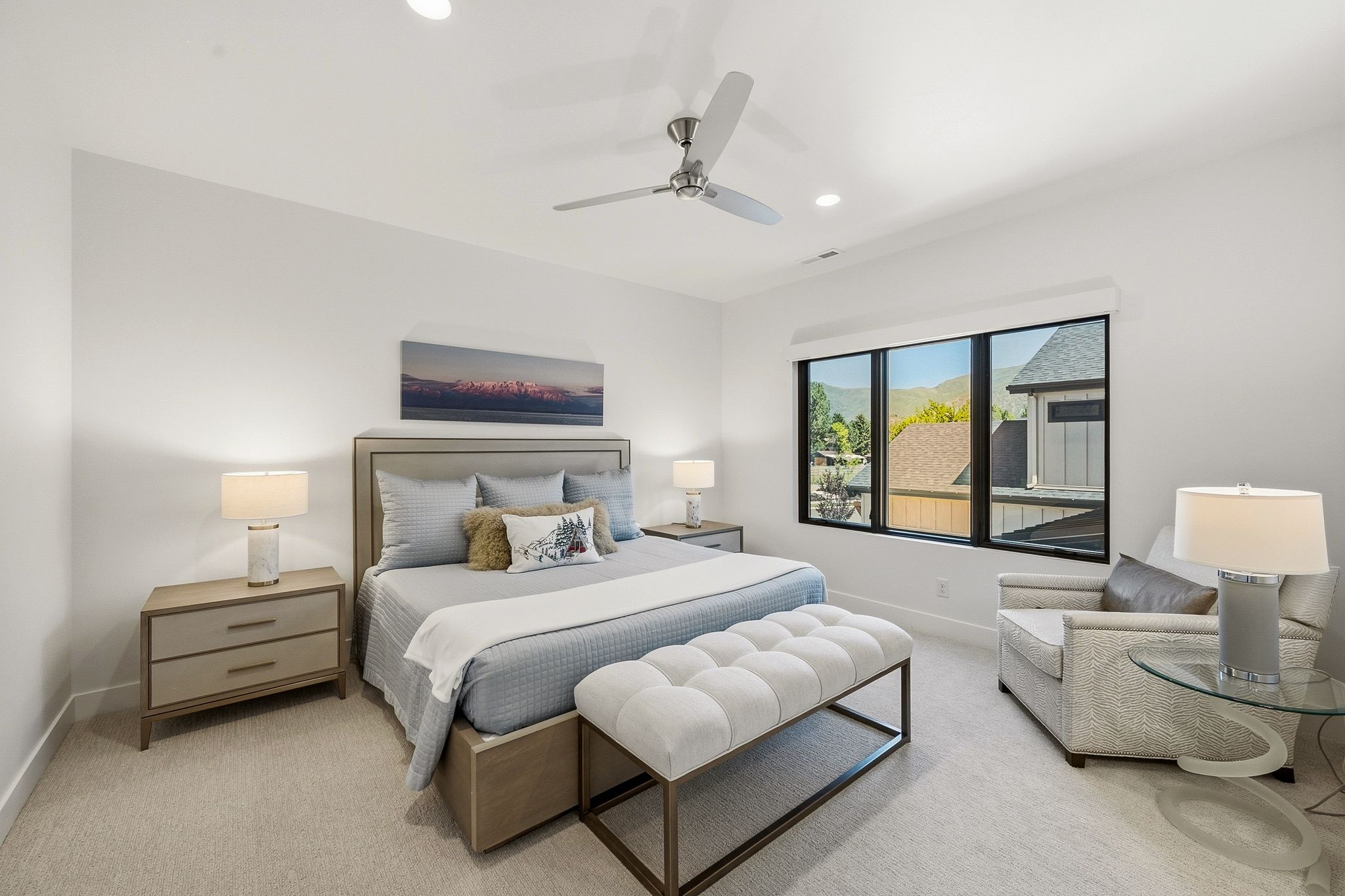 Bright room featuring expansive windows with mountain and neighborhood scenery, recessed lighting, and a ceiling fan