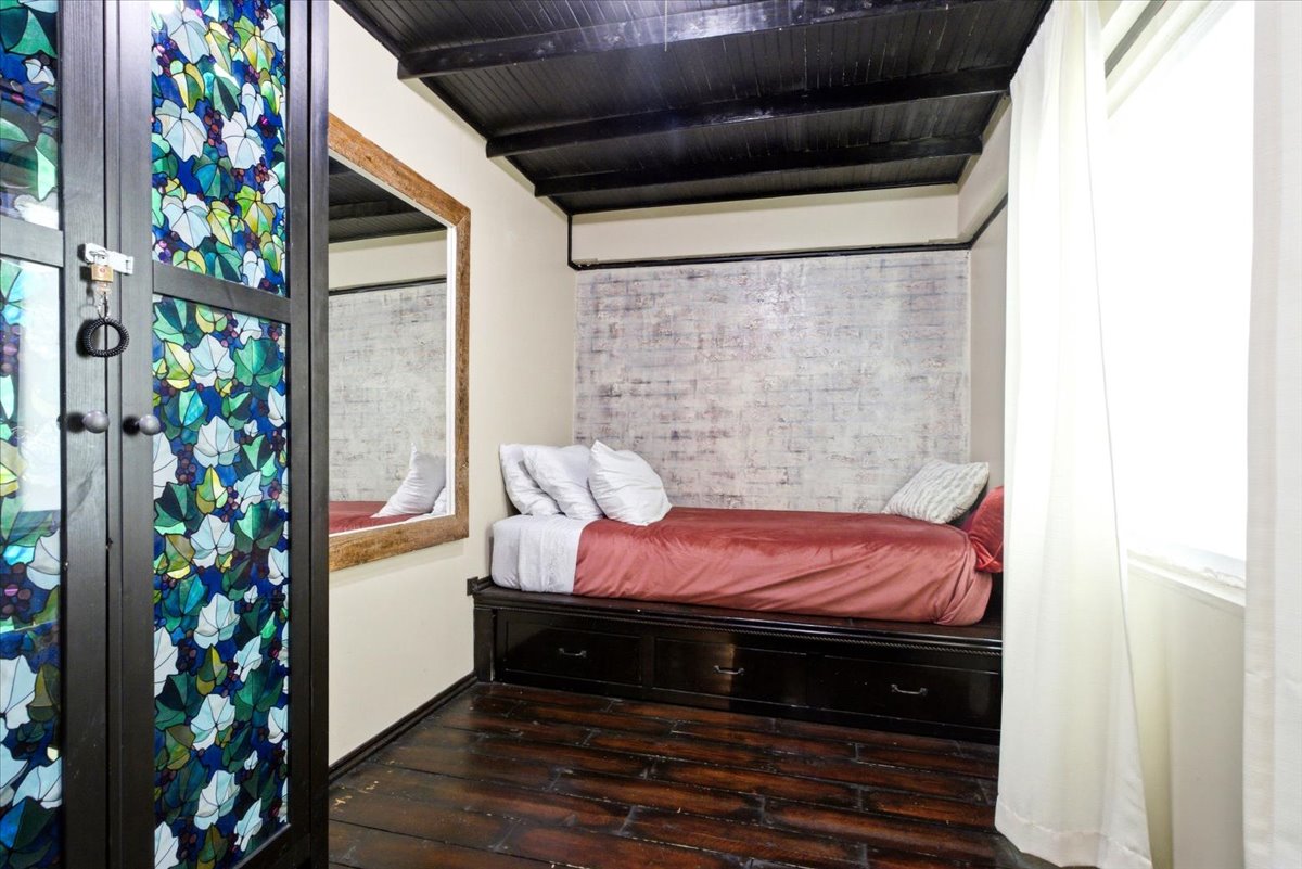Hardwood flooring throughout this room featuring a dark wood ceiling