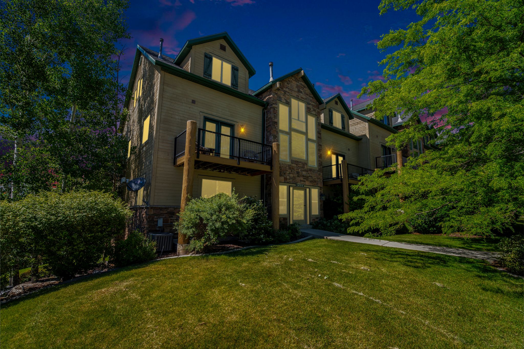 Multi-level property with a stone and siding exterior