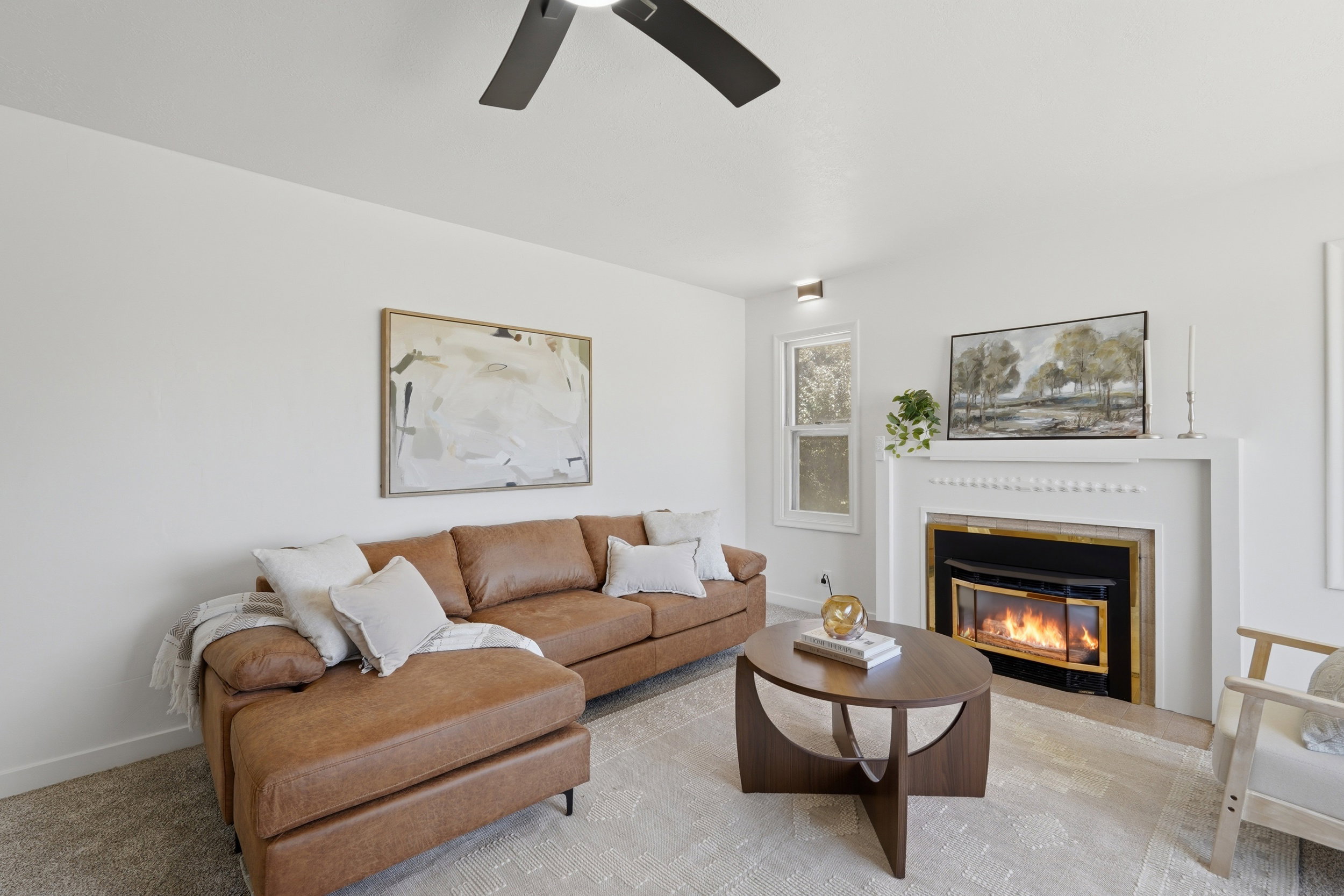 Living area featuring a fireplace with white mantel, a ceiling fan, and recessed lighting