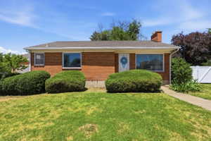 Brick exterior with a gabled roof and white trim
