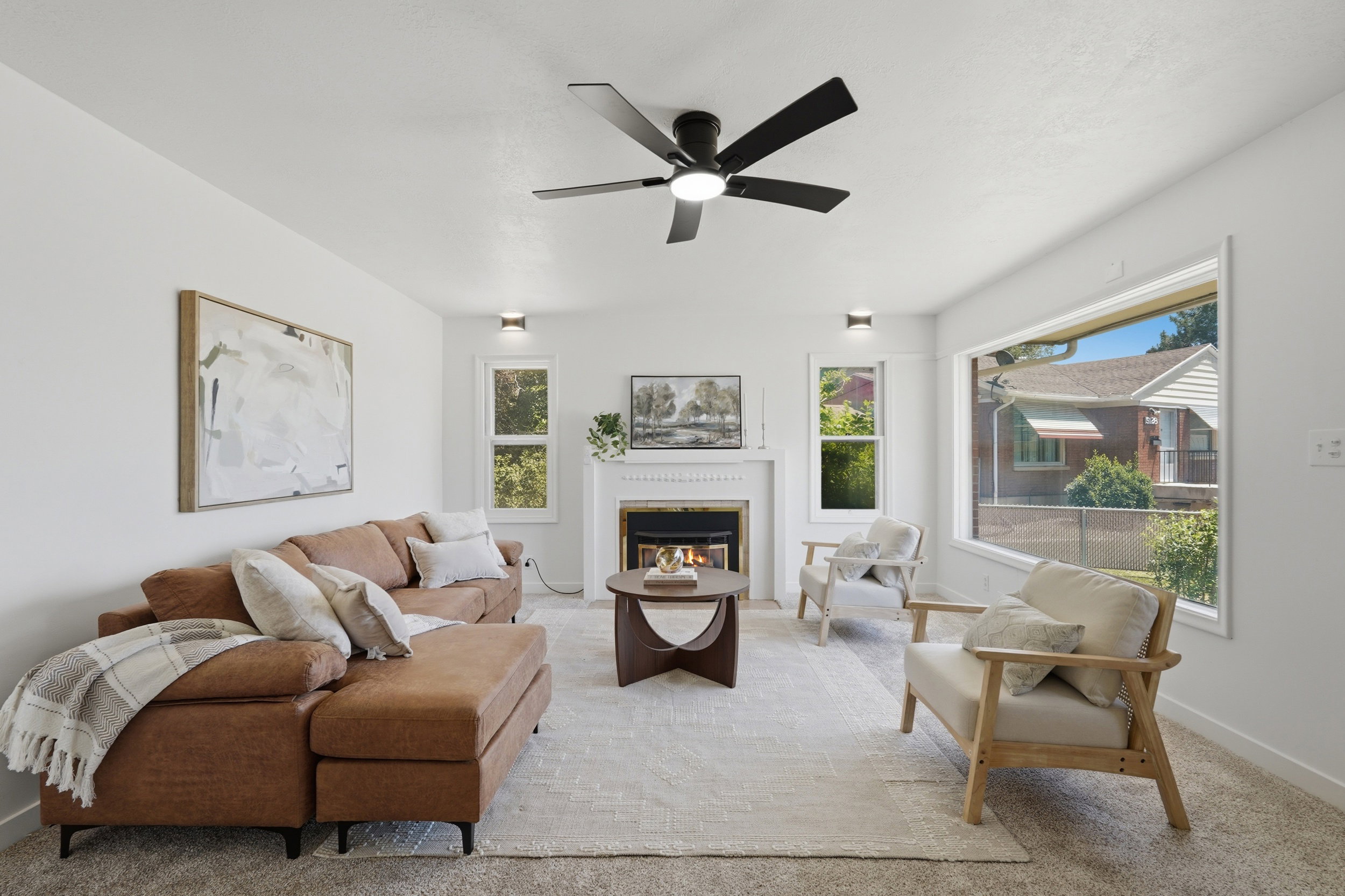 Living area featuring a fireplace with a white mantel, ceiling fan, recessed lighting, and large picture windows