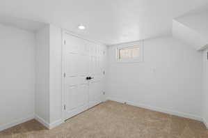 Neutral-toned carpet flooring and white walls