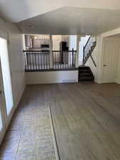 Open-concept living area featuring wood-finish flooring and a tiled entry