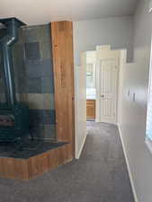 Recessed wood-burning stove with a slate tile surround and wood plank accents