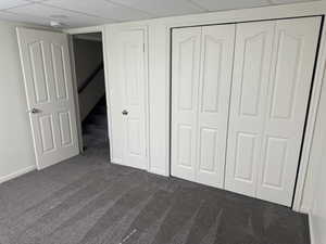 Gray textured carpeting complements the neutral wall color