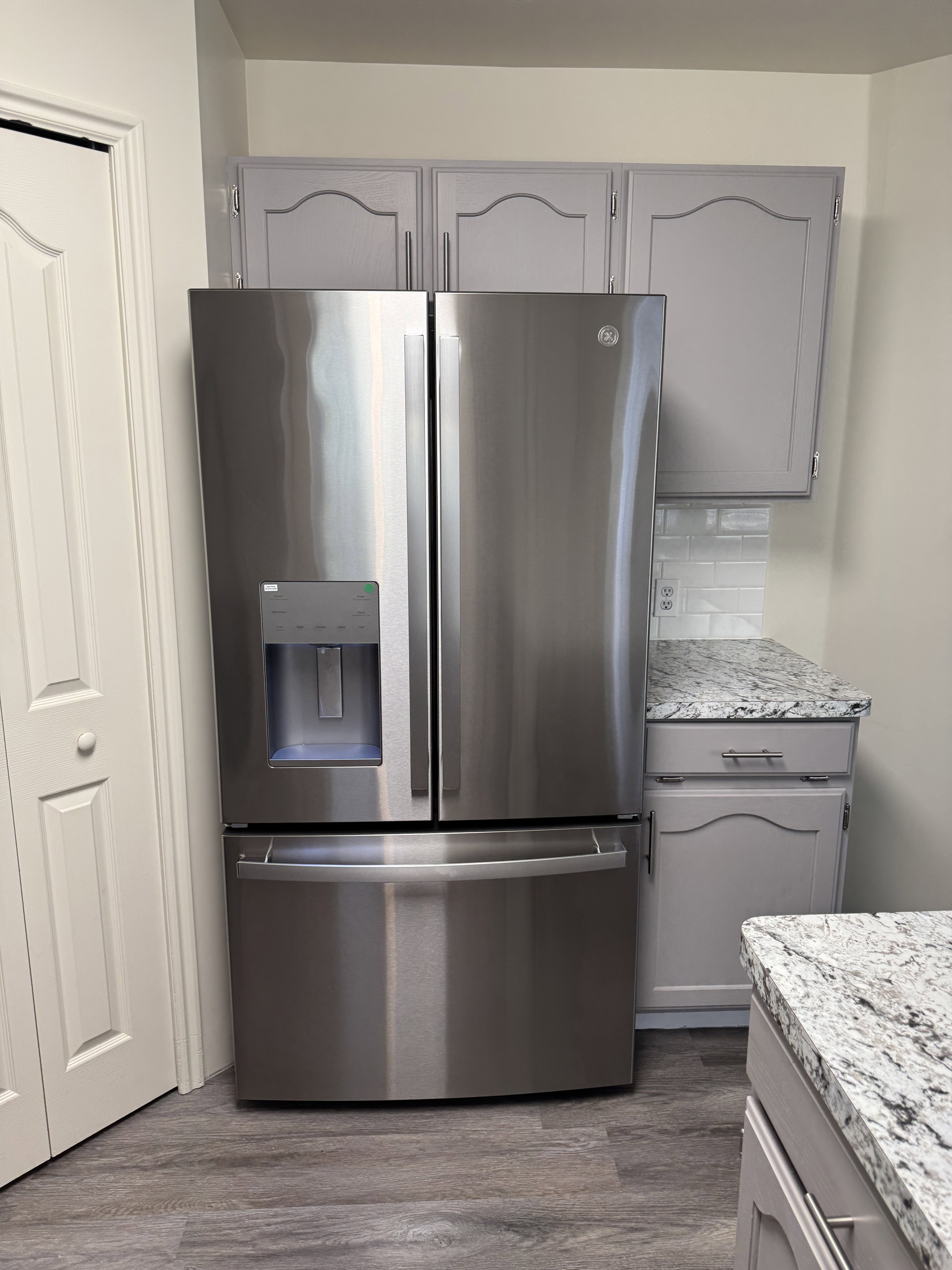 Stainless steel refrigerator with a French door design and bottom freezer drawer