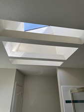 Recessed skylight feature with a rectangular opening and tiered light well, providing natural illumination