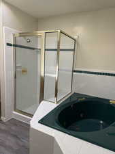 Corner soaking tub and a glass-enclosed shower with gold-tone fixtures