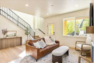 Open-concept living area with light wood-finish flooring
