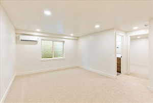 Cream-toned carpeting in a spacious room featuring a window with security grating