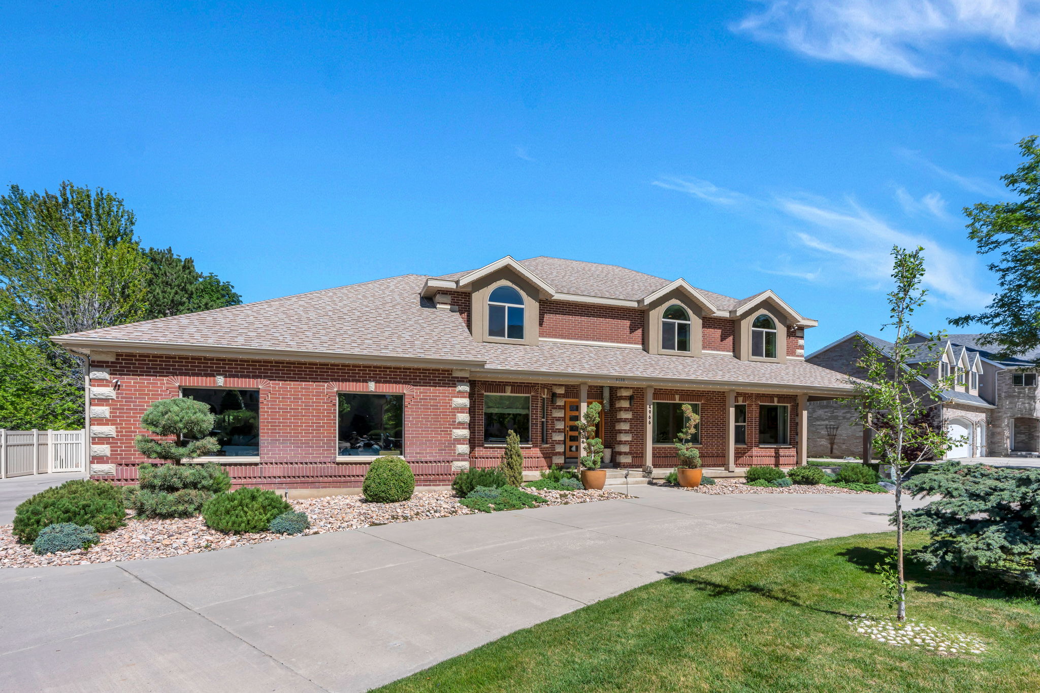 Brick exterior with stone accents and a neutral-toned roof