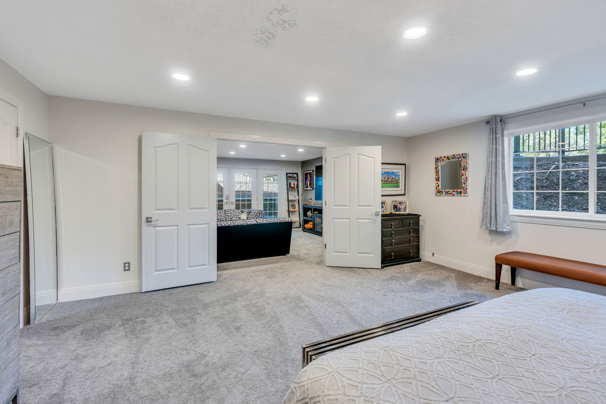 Carpeted room with recessed lighting and a window featuring natural light