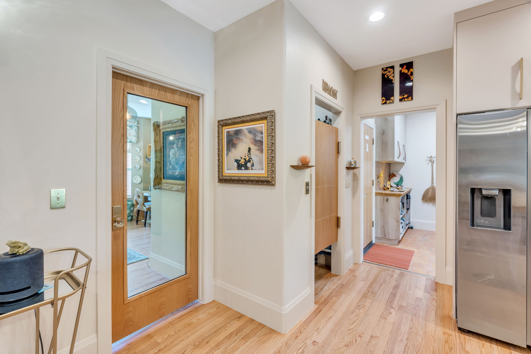 Hardwood-style flooring throughout, featuring a stainless steel French door refrigerator with ice and water dispenser