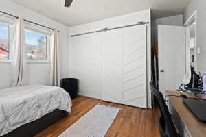 Herringbone pattern barn door closet featuring a stainless steel track