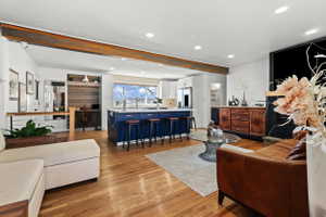 Open-concept living space featuring wood-finish flooring and recessed lighting