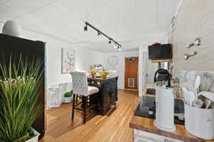 Kitchen area featuring wood-finish flooring, a butcher block countertop, and a built-in cooktop