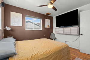 Wood-finish flooring with a ceiling fan overhead