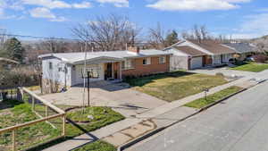 Ranch-style residence featuring brick and siding exterior, an attached garage, and a concrete driveway
