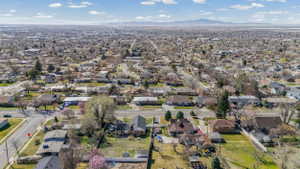 Residential neighborhood setting with established tree-lined streets and distant mountain ranges