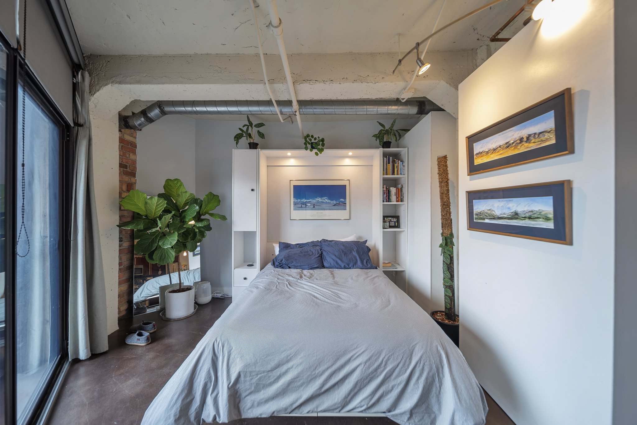 Bedroom featuring a built-in bed frame with integrated shelving and cabinetry