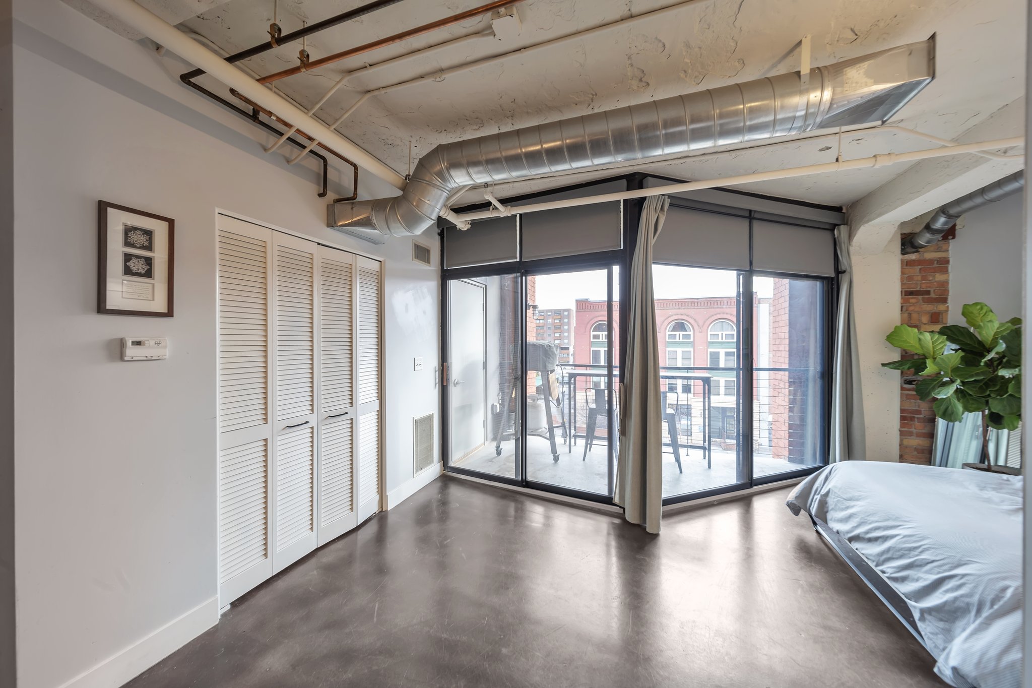 Concrete flooring with exposed ceiling ductwork and piping
