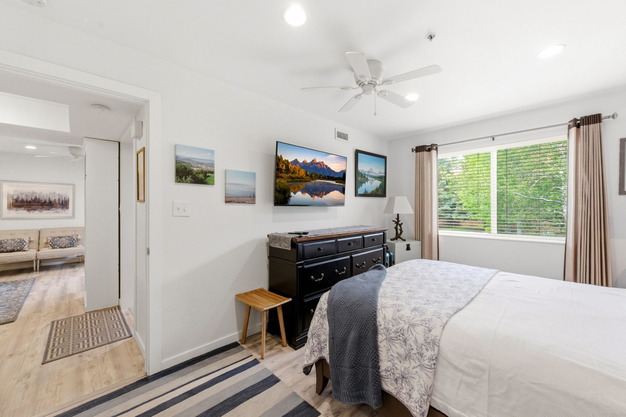 Bedroom featuring a large window, light wood-finish flooring, recessed lighting, and a ceiling fan