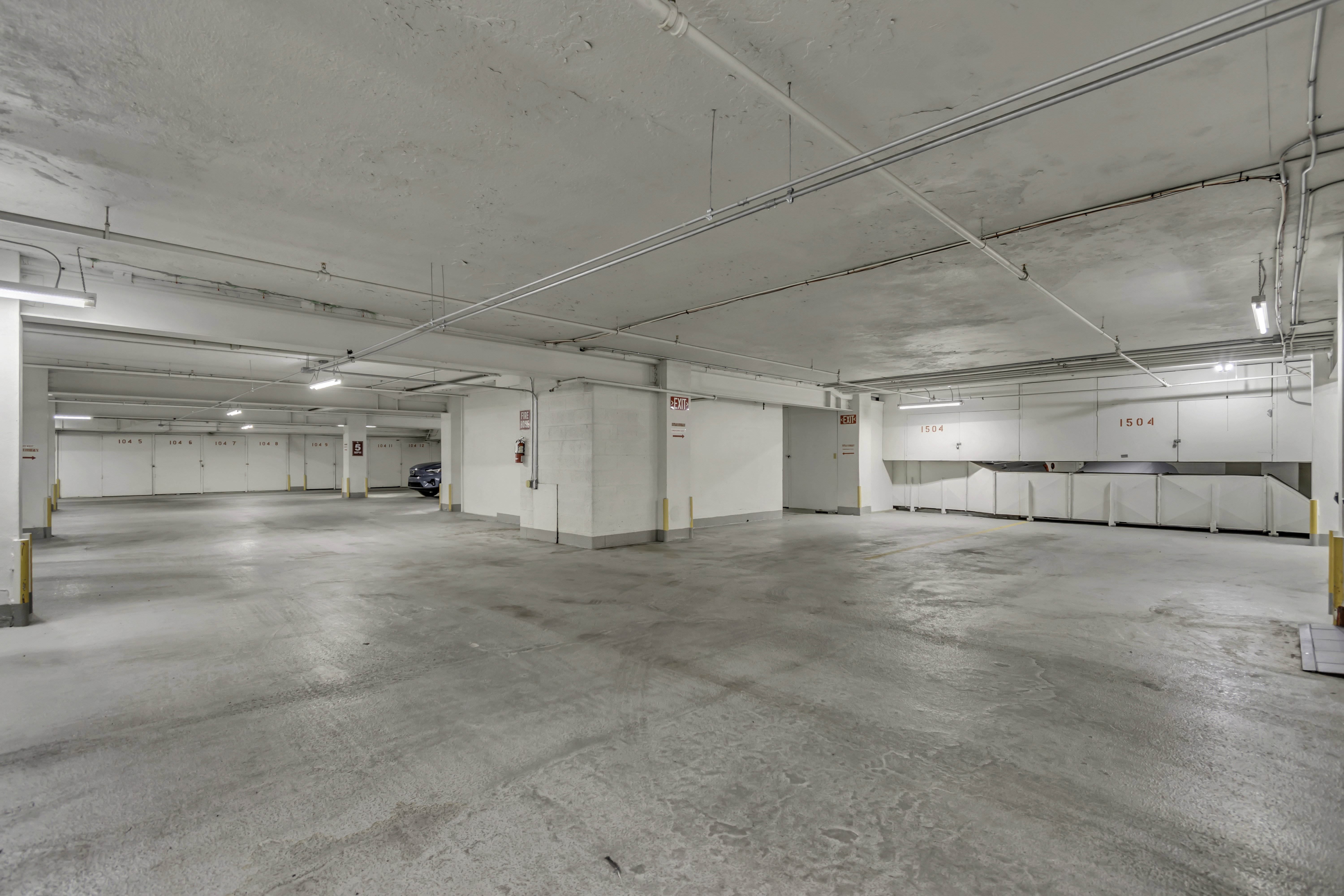 Subterranean parking garage with concrete flooring