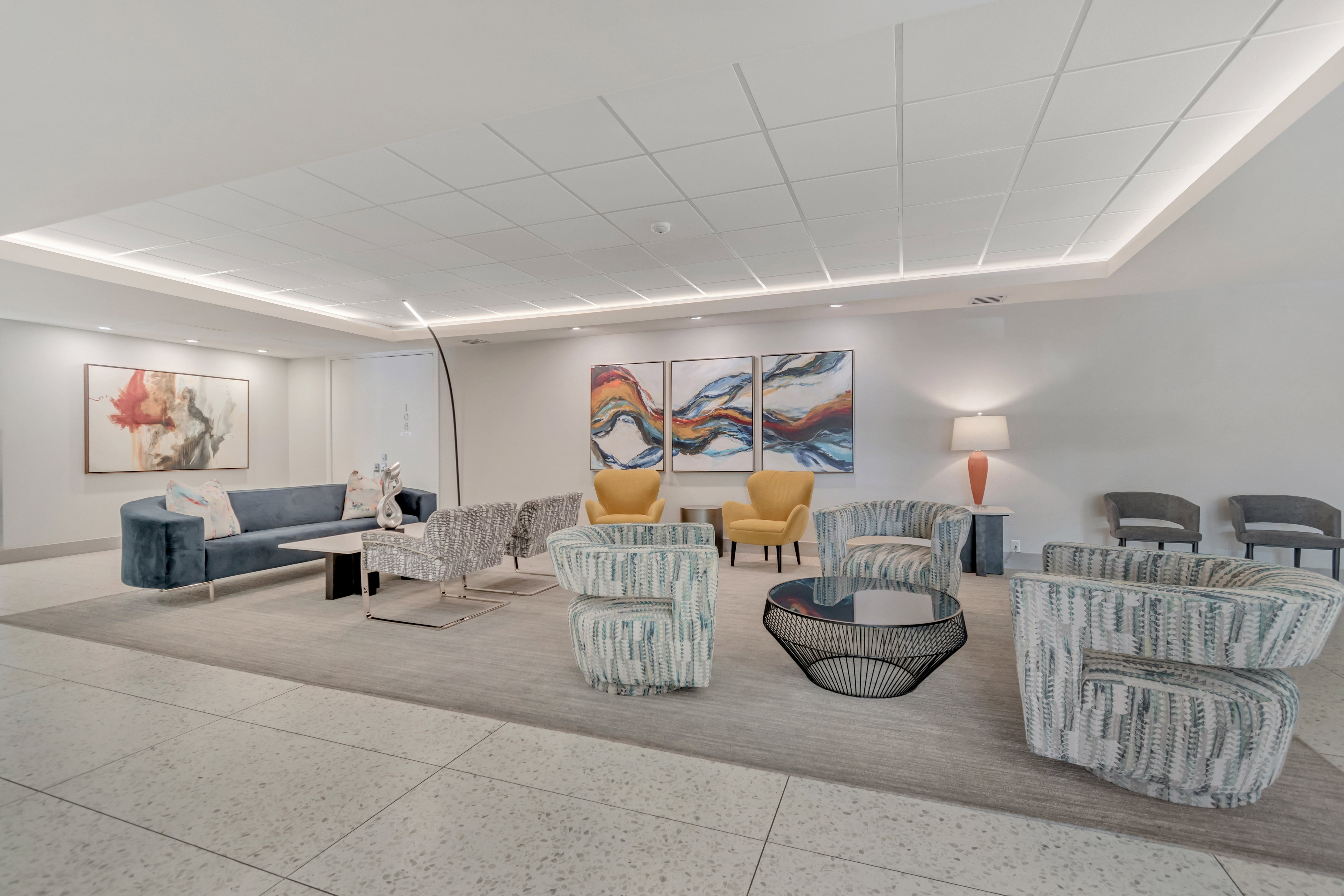 Spacious common area featuring recessed lighting, a coffered ceiling, and large format tile flooring