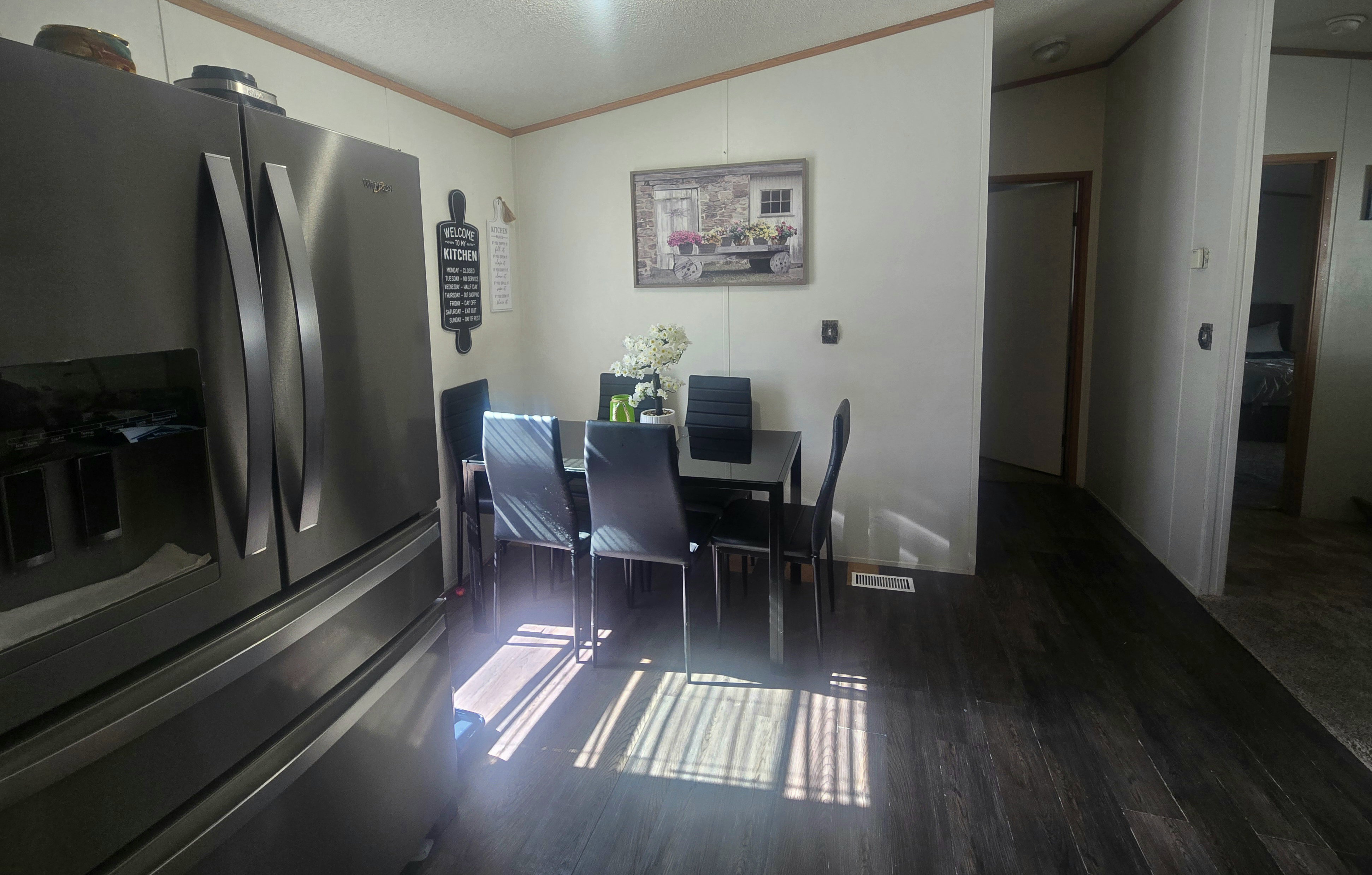Dining area with wood-finish flooring, featuring a dedicated space for a dining table