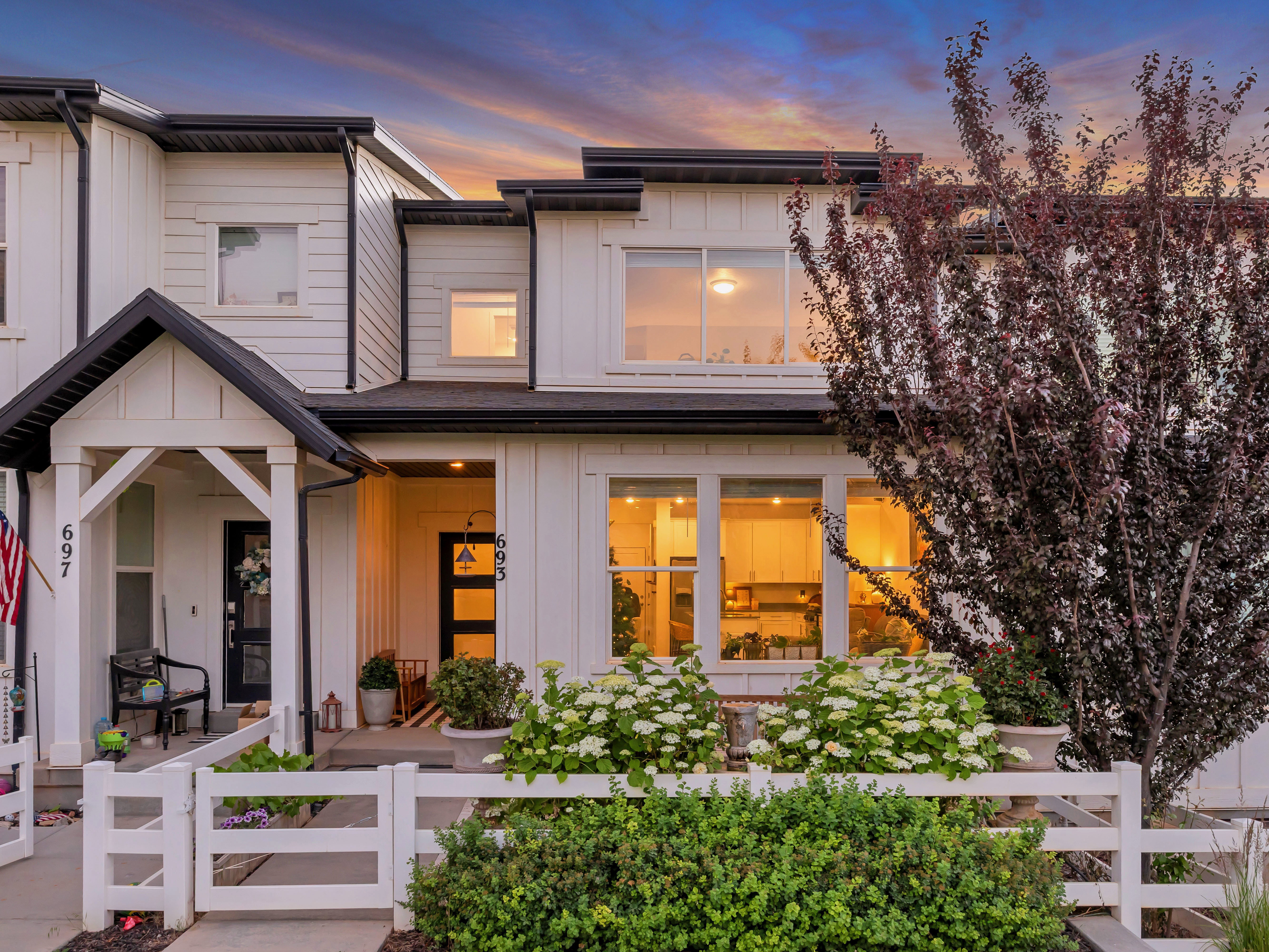 Modern exterior with white siding and black trim accents