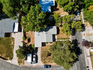 Residential property featuring a grey roof and mature trees