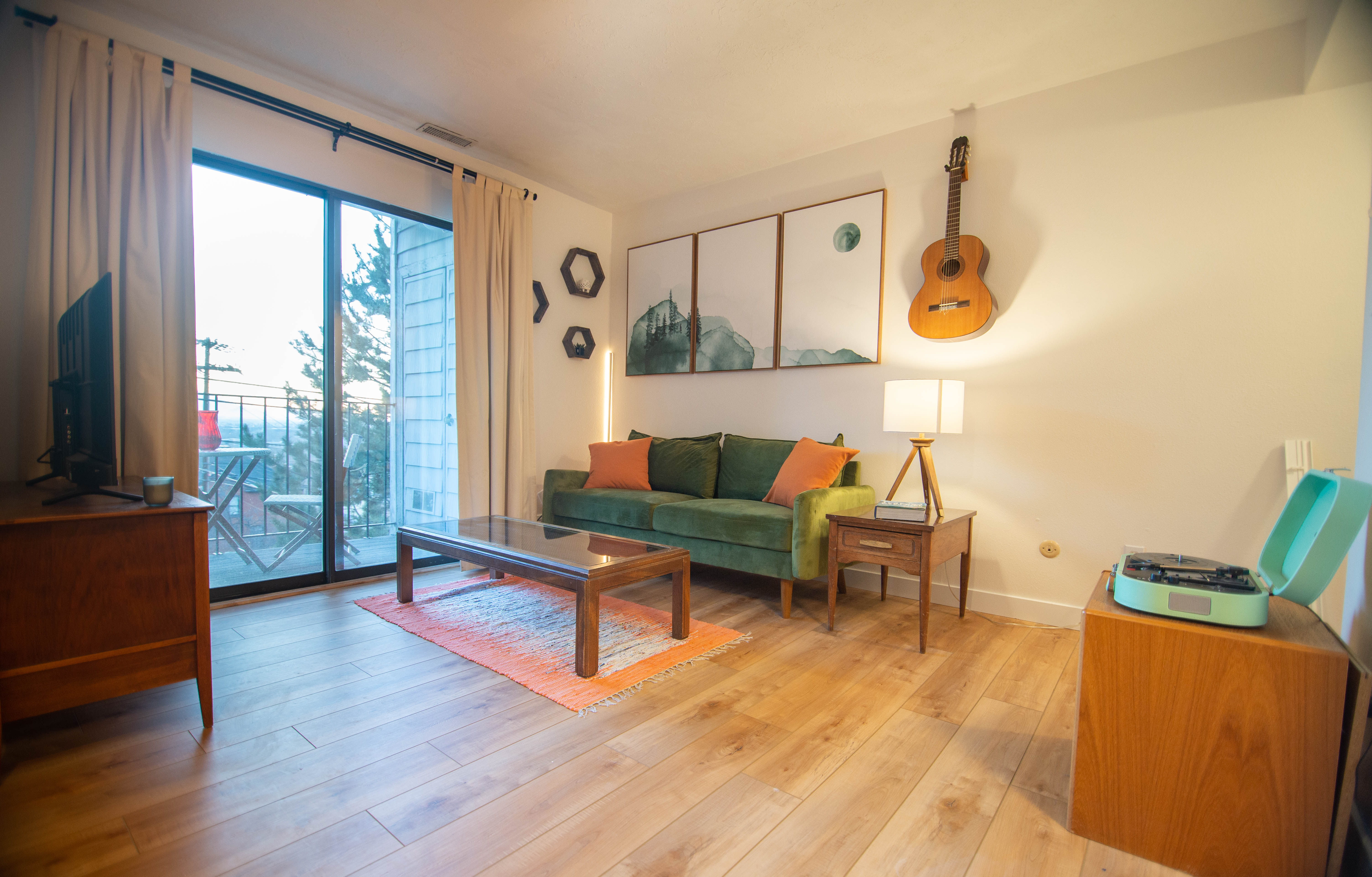 Living space featuring wood-finish flooring and direct balcony access through sliding glass doors