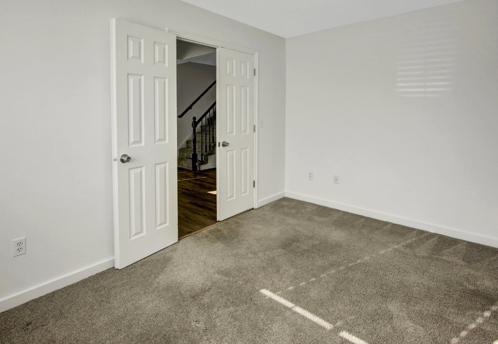 Room featuring neutral-toned carpet flooring and white walls