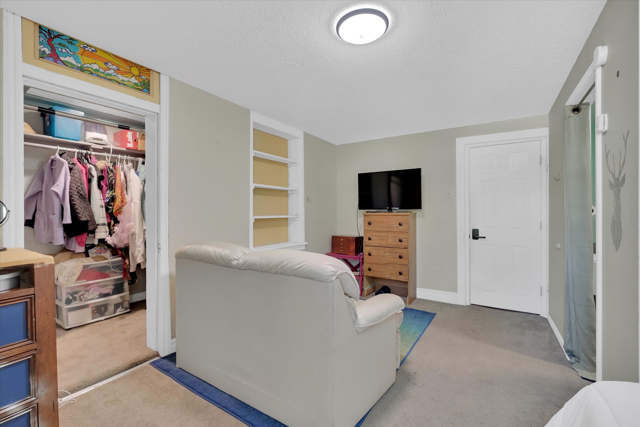 Interior space featuring neutral wall tones and carpeted flooring