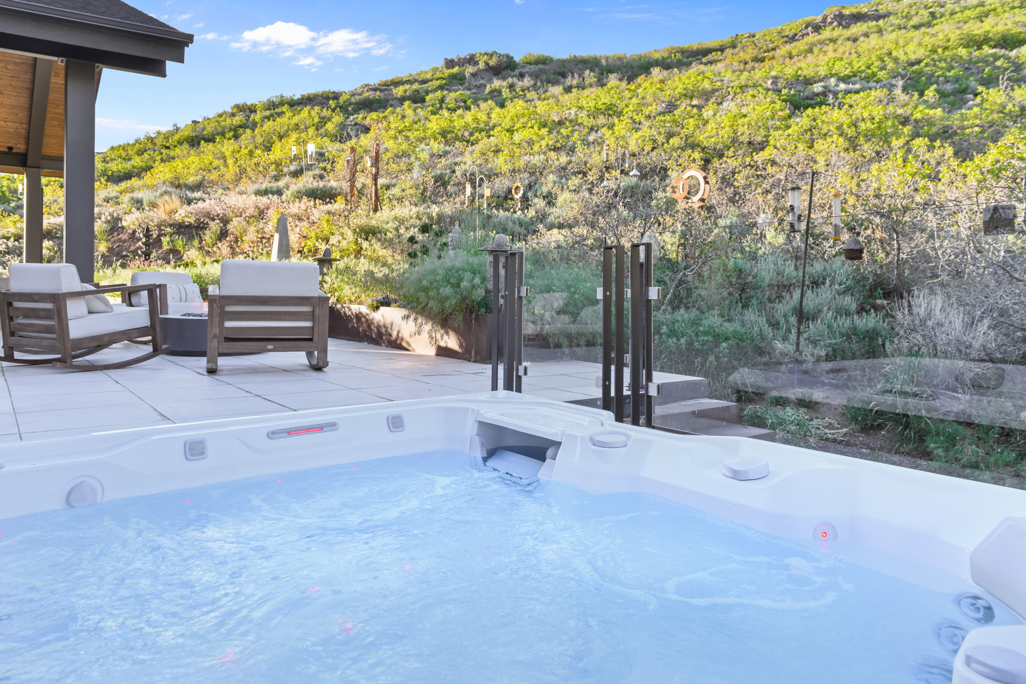 Outdoor spa with bubbling water, set on a paver patio