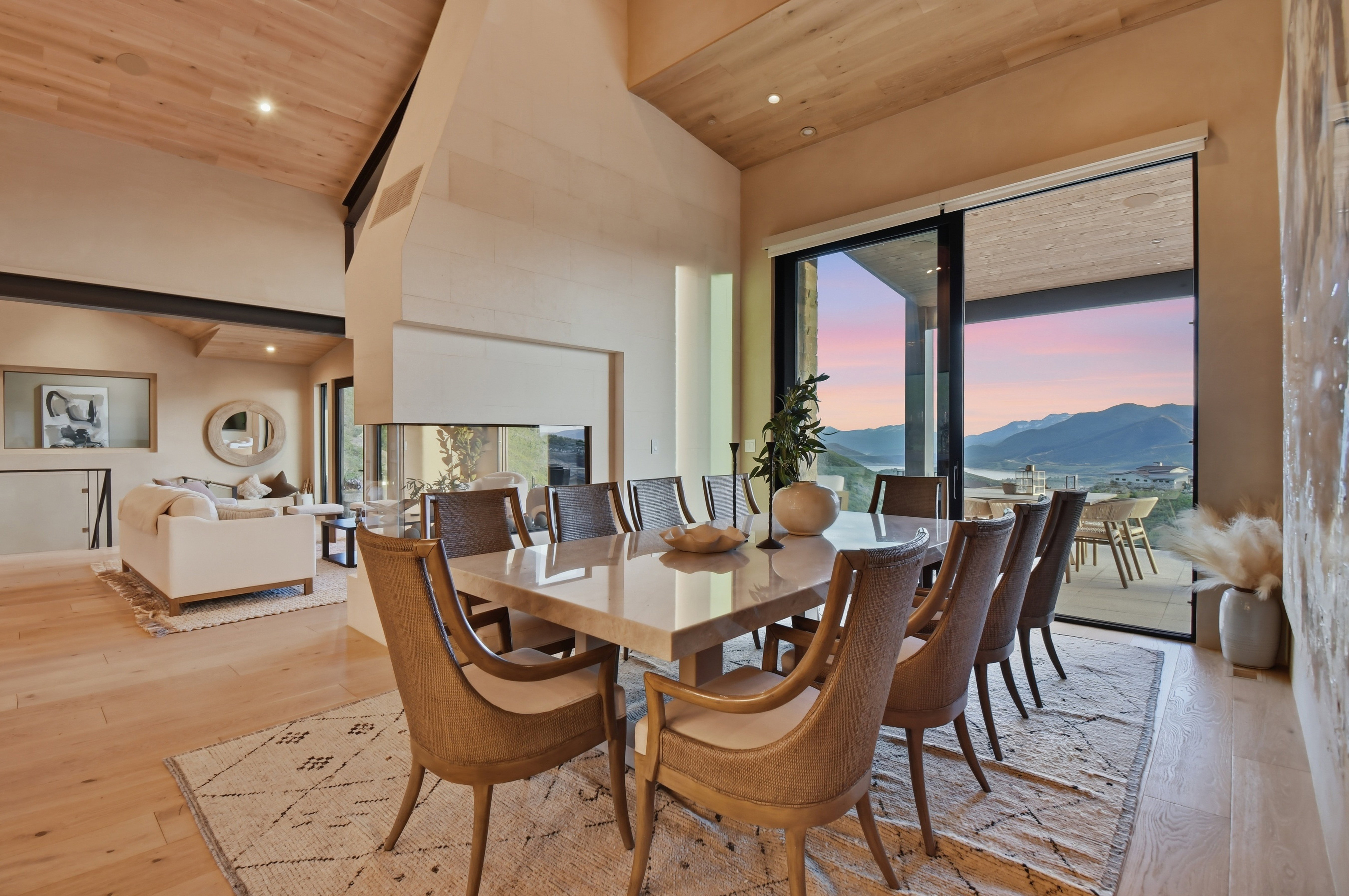 Open-concept dining area featuring a stone-finish dining table and wood-finish flooring