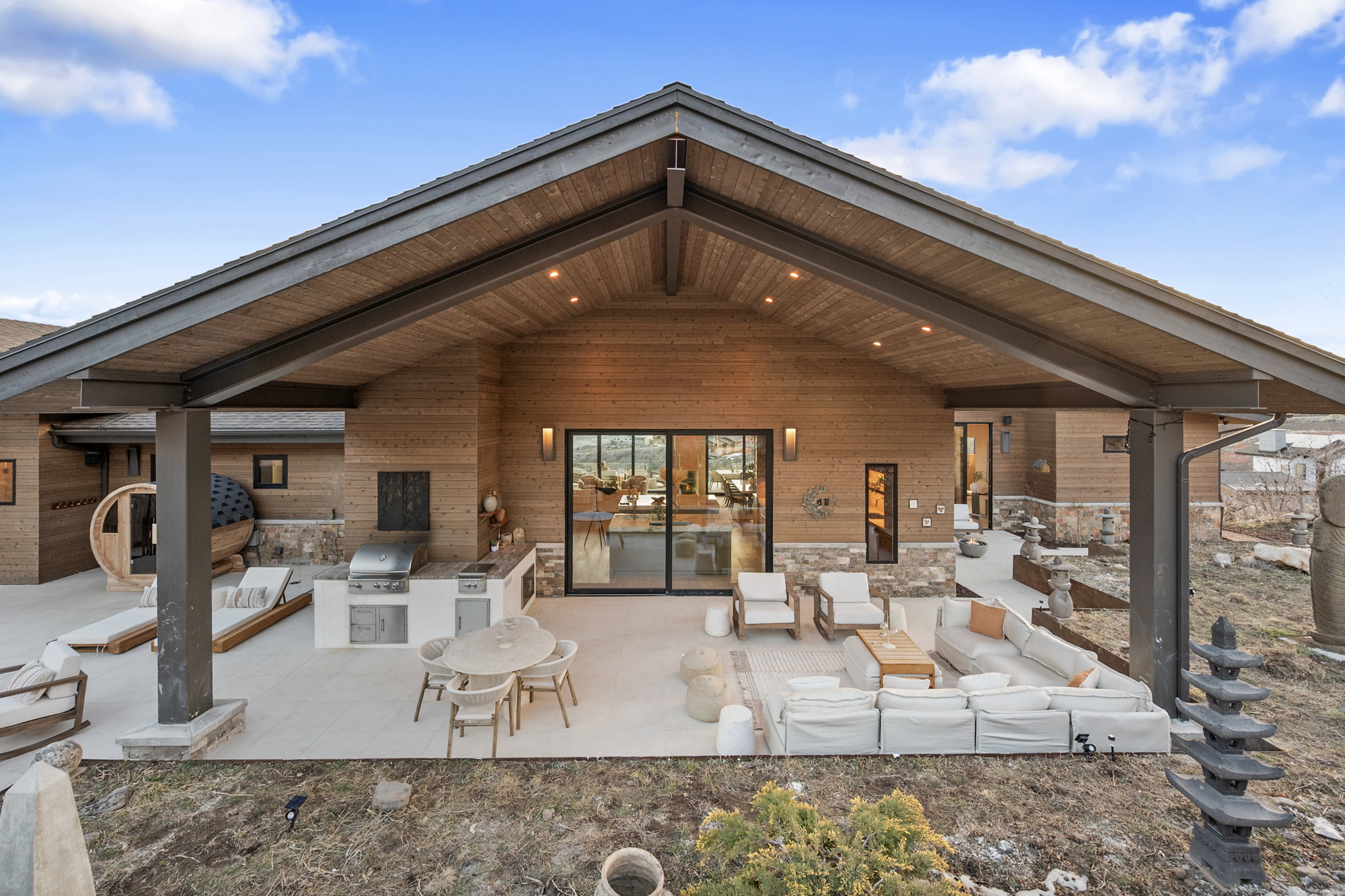 Expansive covered patio featuring a wood-paneled ceiling with recessed lighting