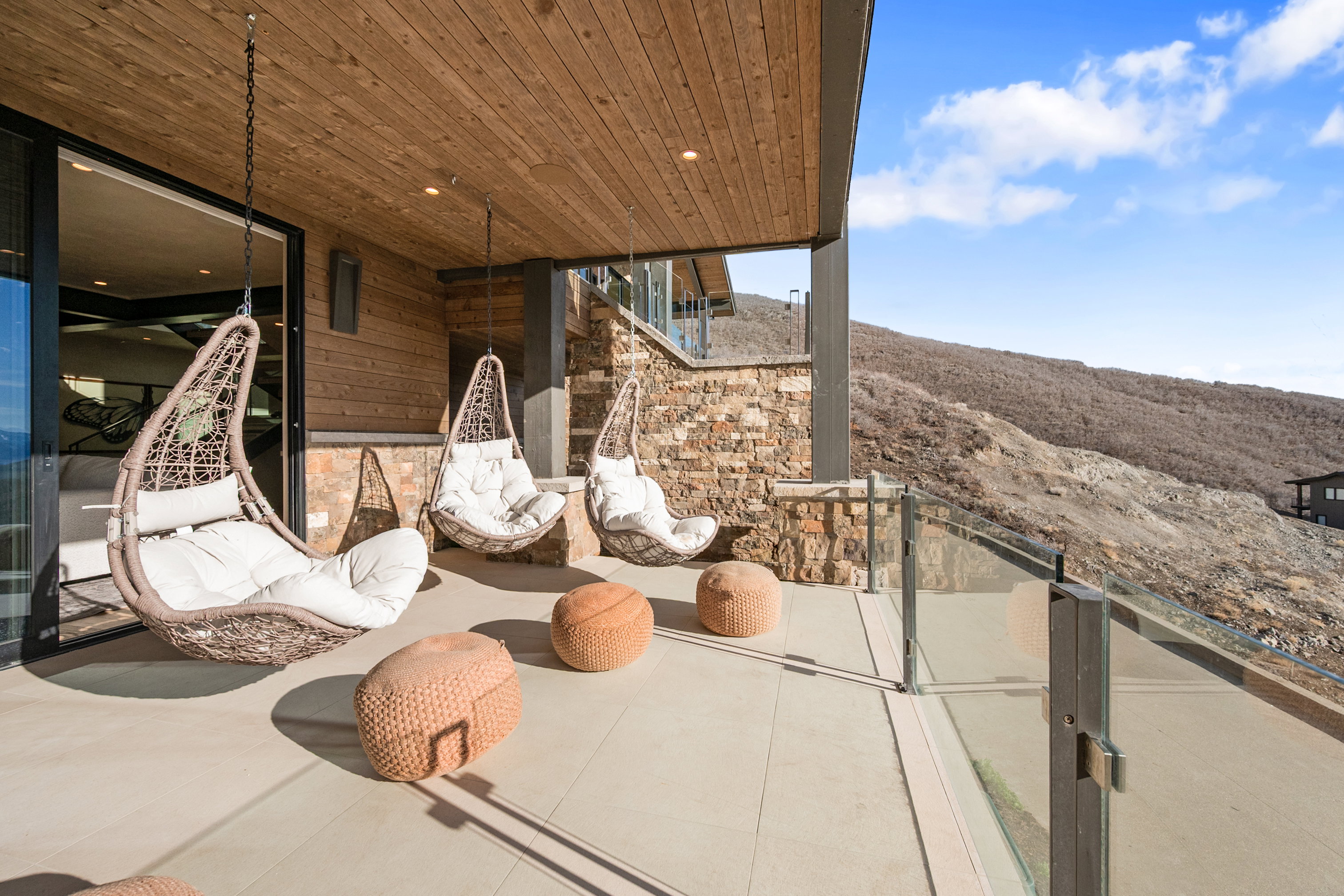 Expansive patio featuring a glass railing and wood-finish ceiling