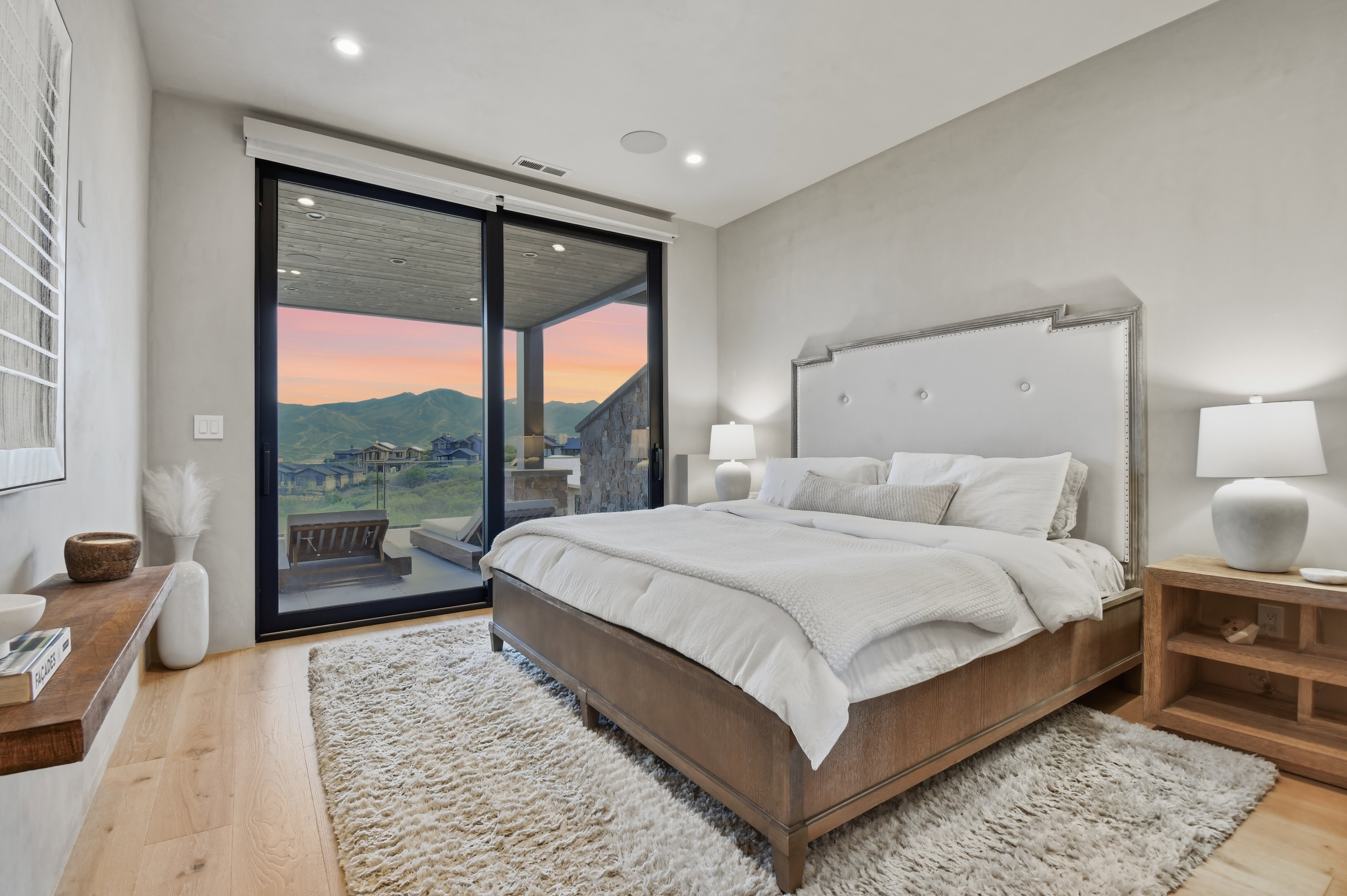 Spacious room featuring wood-finish flooring, a large sliding glass door opening to an exterior patio, recessed lighting, and a neutral wall finish