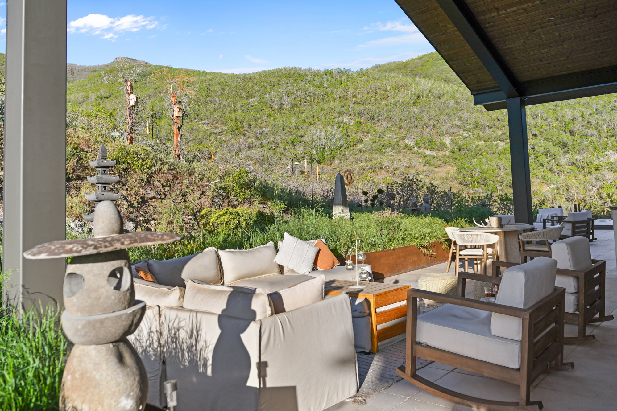 Expansive outdoor patio featuring a concrete slab foundation, a substantial overhead covering, and integrated support columns