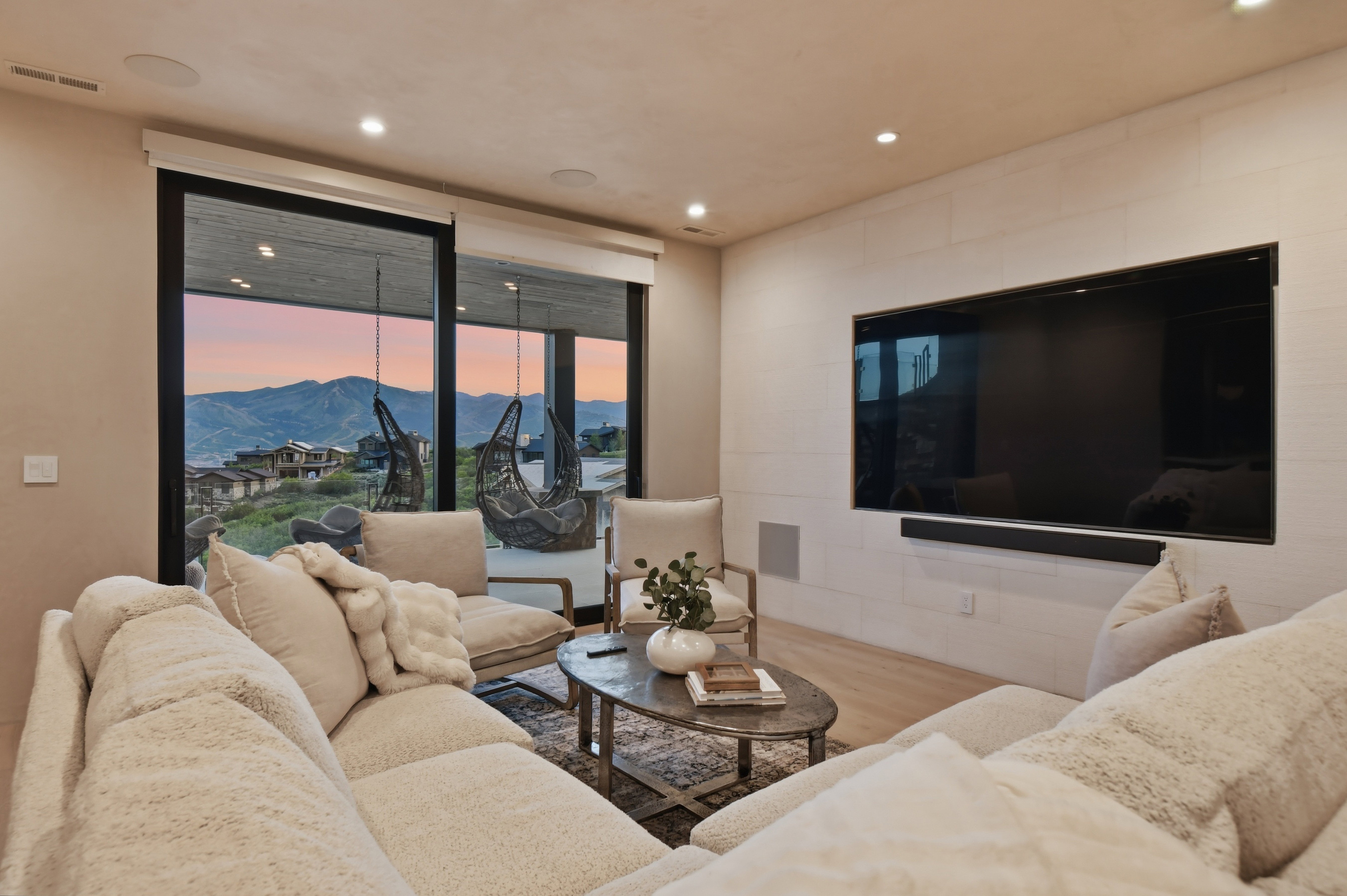 Sliding glass doors opening to a scenic mountain backdrop