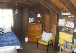 Room featuring exposed wood beam ceilings and wood-paneled walls